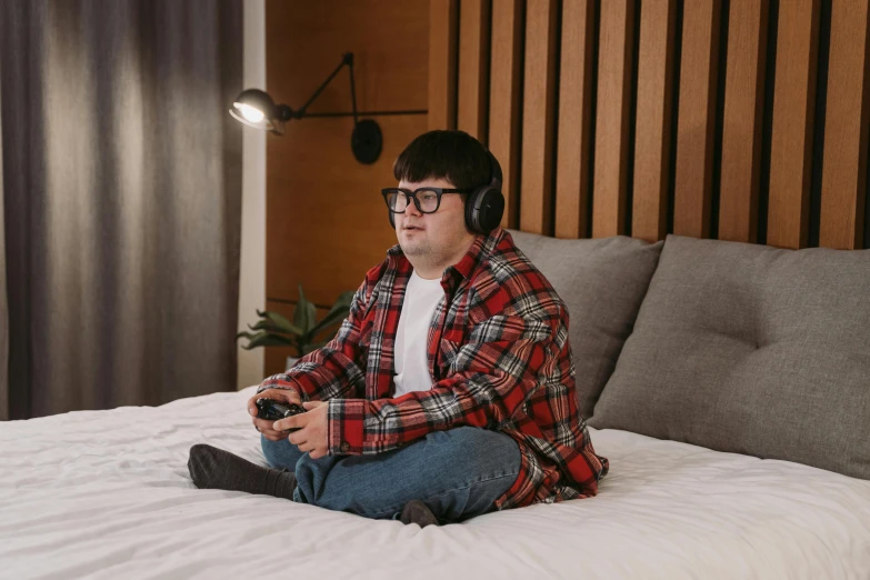 a man sitting on a bed with headphones on, trending on pexels, pixel art, overweight!! teenage boy, tabletop gaming, thick glasses, flannel