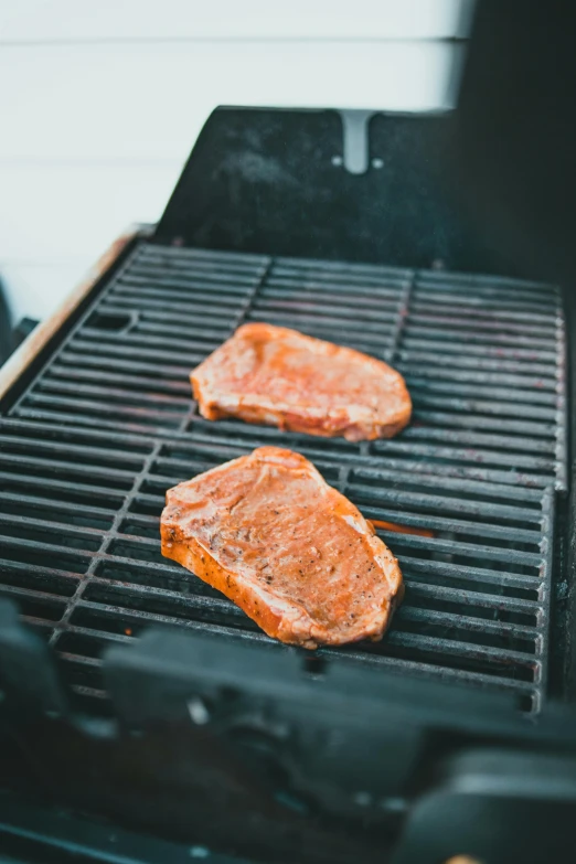 two steaks are cooking on a grill, by Julia Pishtar, unsplash, square, inspect in inventory image, single subject, 5k