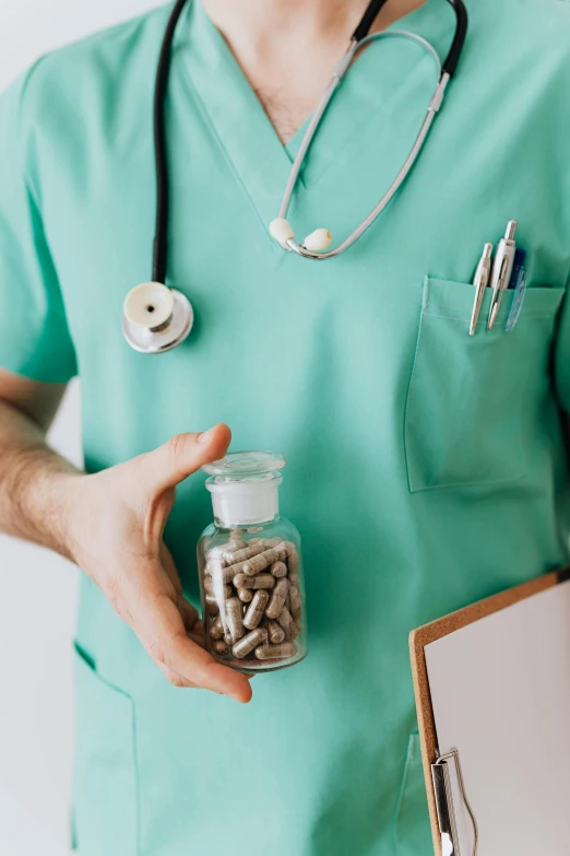 a male doctor holding a clipboard and a jar of pills, a colorized photo, by Adam Marczyński, pexels, maggots, contain