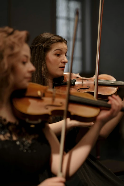 a woman in a black dress playing a violin, ruan jia and mandy jurgens, medium close up shot, profile image, rectangle