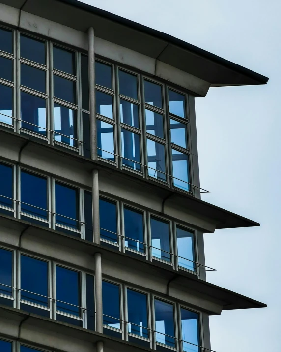 a clock that is on the side of a building, inspired by Tadao Ando, unsplash, modernism, thumbnail, steel window mullions, stacked image, hannover