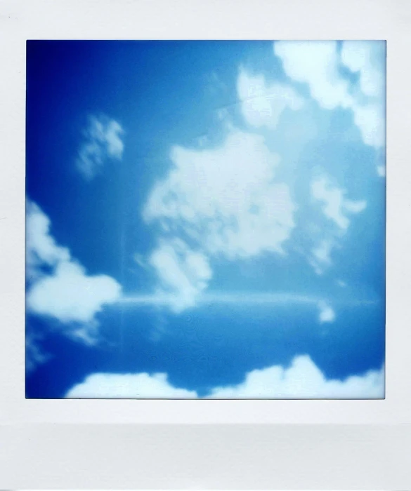 a polaroid picture of a blue sky with clouds, by Nathalie Rattner, conceptual art, frank franzzeta, 2015, nimbus