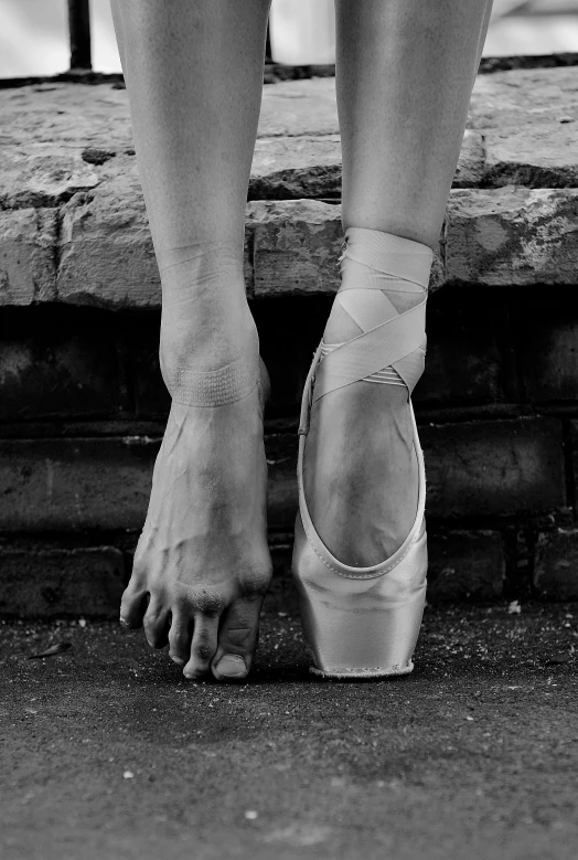 a black and white photo of a ballerina's feet, by Elizabeth Polunin, terrified 👿, cracked, the forefoot to make a v gesture, standing on the street