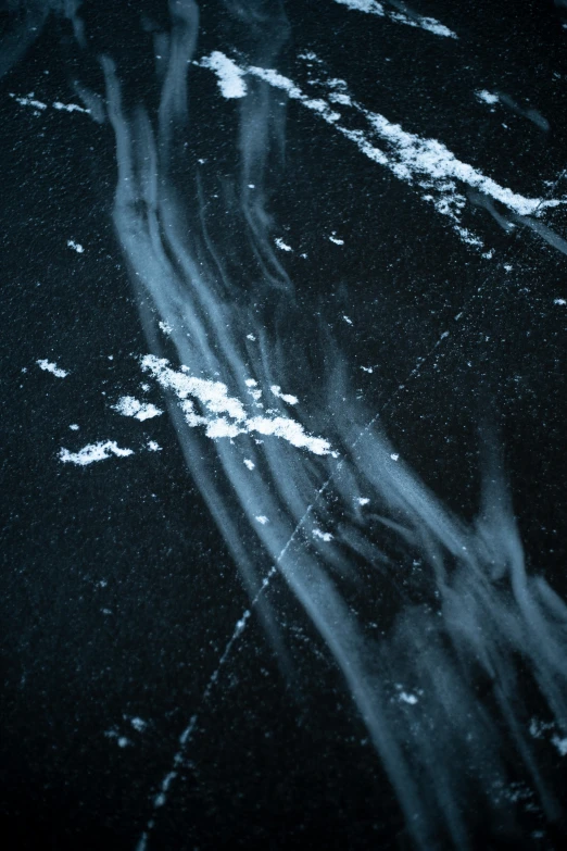 a black and white photo of a person on a skateboard, a microscopic photo, inspired by Vija Celmins, trending on unsplash, space art, glowing blue veins, smoke and debris, close up of single sugar crystal, night sky; 8k
