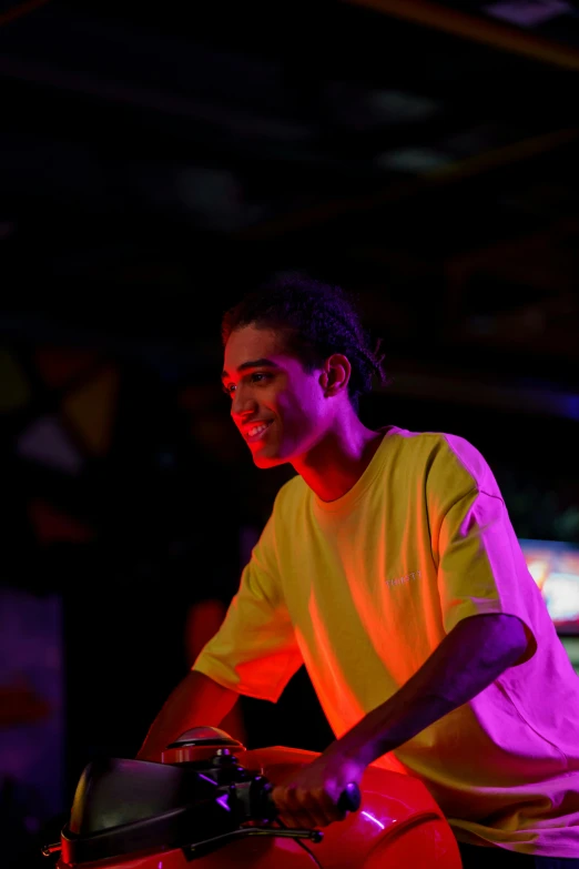 a man riding on the back of a red motorcycle, a portrait, happening, reflecting light in a nightclub, jayison devadas, profile image, glowing yellow face