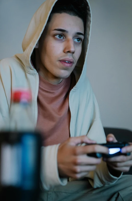 young man with hoodie looking at cellphone