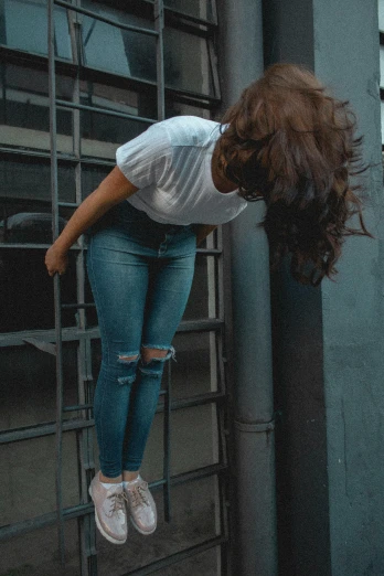 a woman flying through the air while riding a skateboard, inspired by Elsa Bleda, pexels contest winner, happening, standing astride a gate, ripped jeans, face down, gif