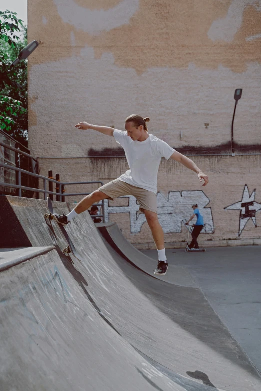 a man riding a skateboard up the side of a ramp, curved, dasha taran, highly upvoted, center focused