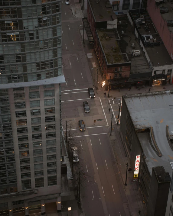 an aerial view of a city street at night, an album cover, pexels contest winner, vancouver school, non-binary, city morning, hotel room, low quality photo