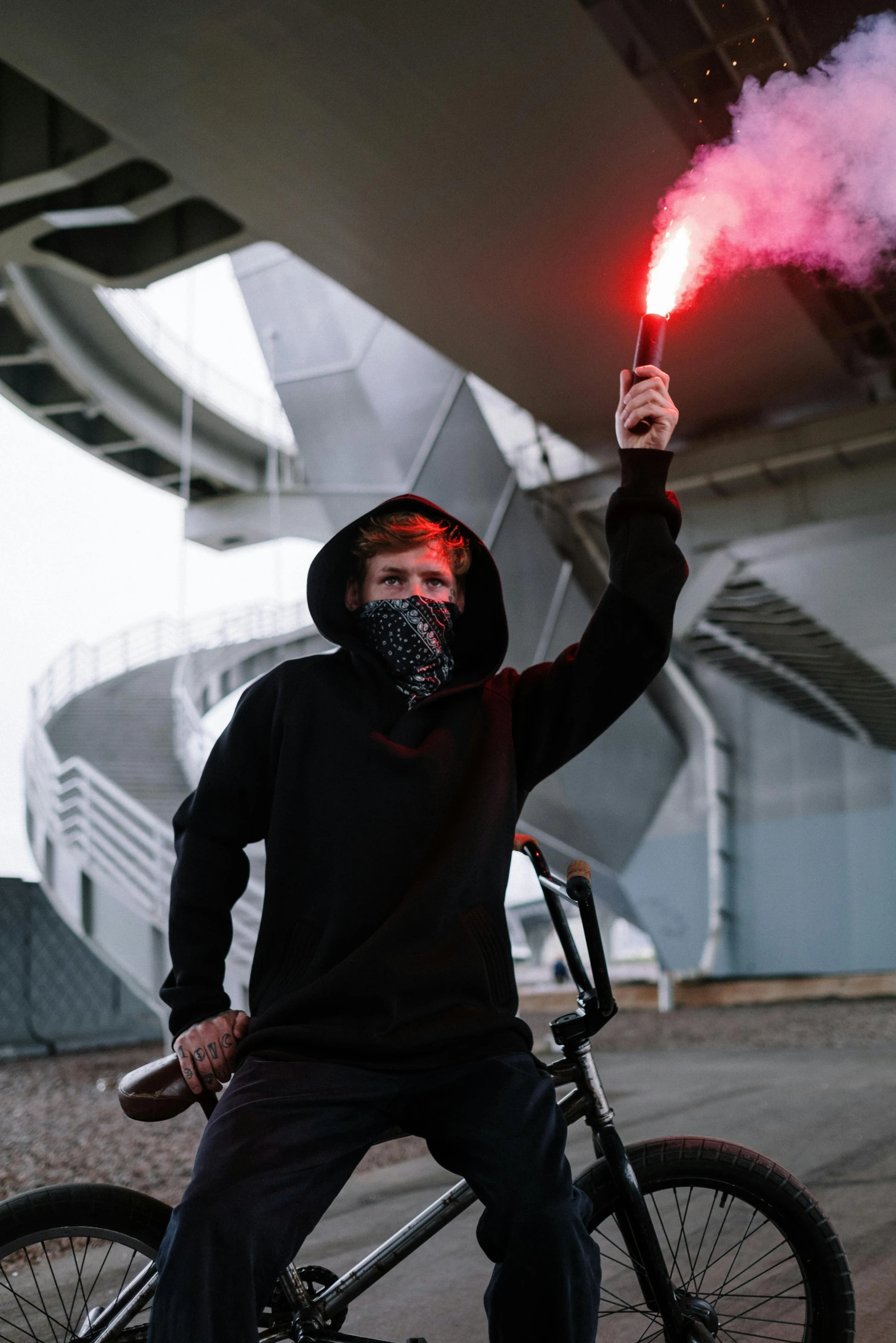 a man on a bike with smoke coming out of his mouth, pexels contest winner, graffiti, holding a red lightsaber, soccer players timo werner, wearing sith hood, vantablack gi