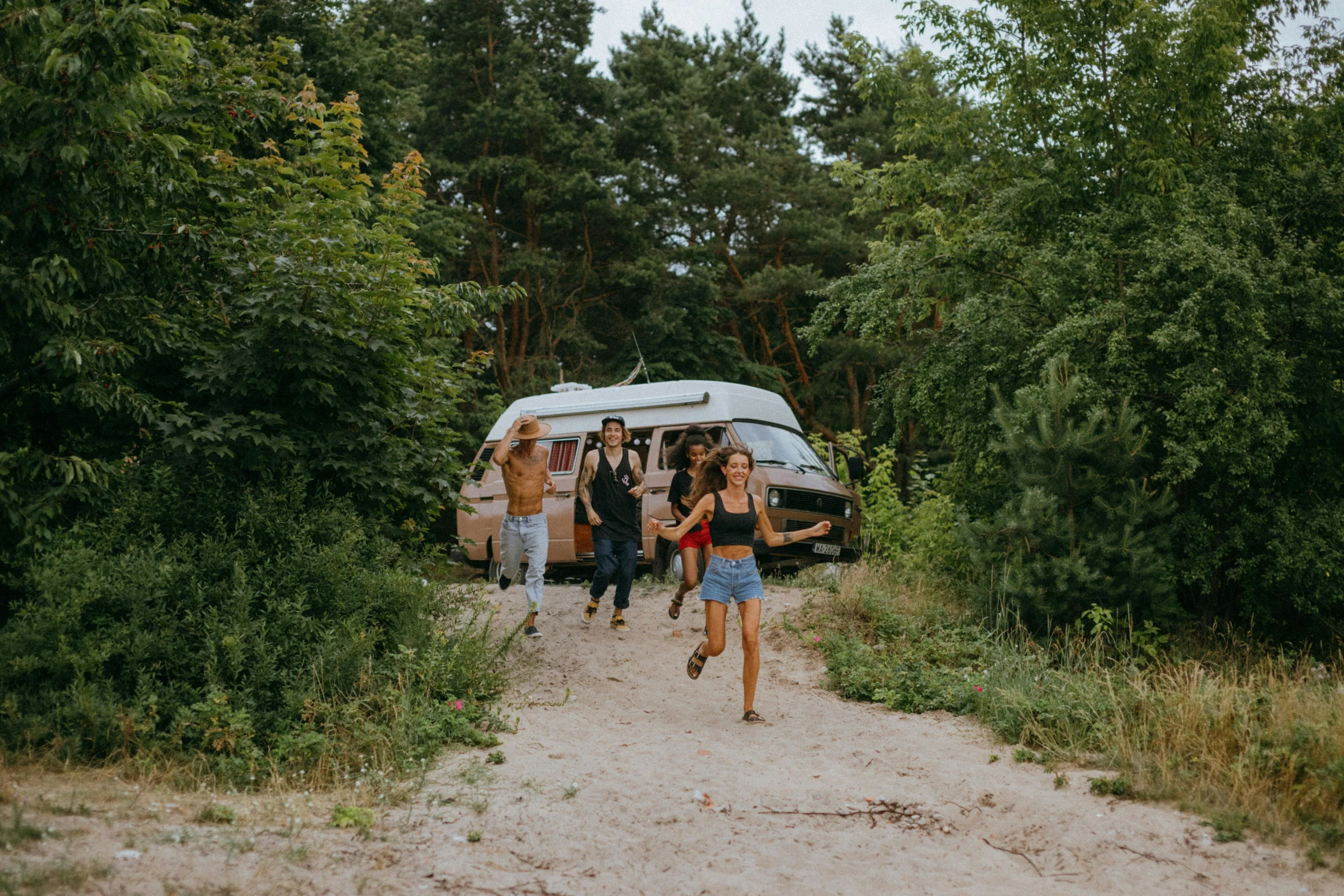 a group of people walking down a dirt road, by Adam Marczyński, pexels contest winner, microbus, forest picnic, avatar image