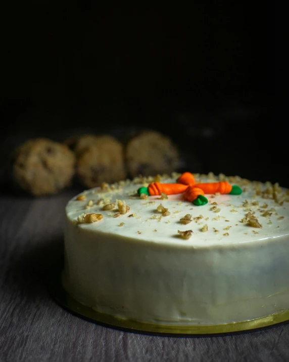 a cake sitting on top of a wooden table, by Robbie Trevino, pexels, carrots, egypt, on a gray background, bun )