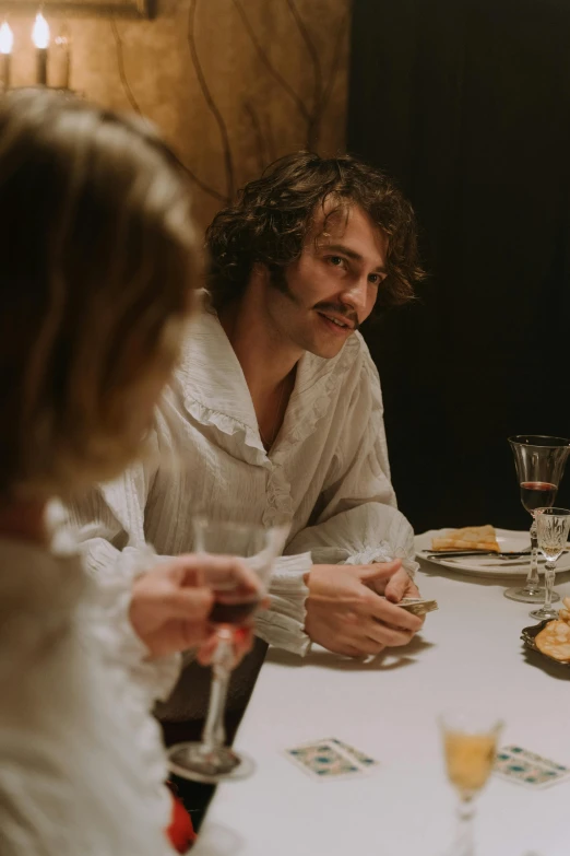 a group of people sitting around a dinner table, a portrait, inspired by Henri-Julien Dumont, unsplash, renaissance, medium shot of two characters, [ theatrical ], victorian era, linen