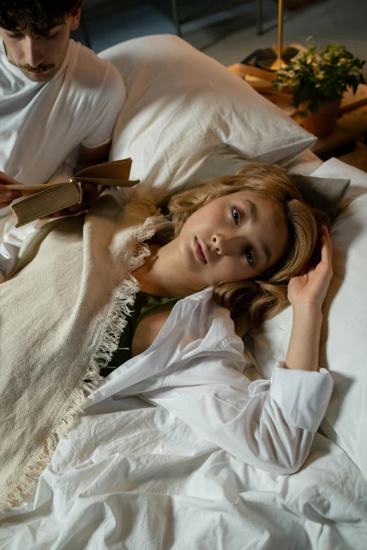 a woman laying on top of a bed next to a man, an album cover, inspired by Vasily Perov, trending on pexels, renaissance, side portrait of imogen poots, japanese live-action movie, victorian clothing, linen