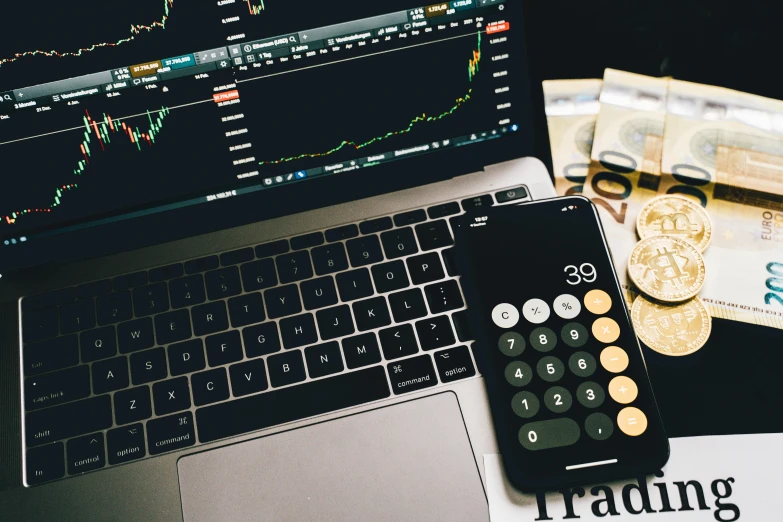 a laptop computer sitting on top of a desk next to a calculator, by Adam Rex, trending on unsplash, analytical art, trading stocks, thumbnail, currency symbols printed, 🦩🪐🐞👩🏻🦳