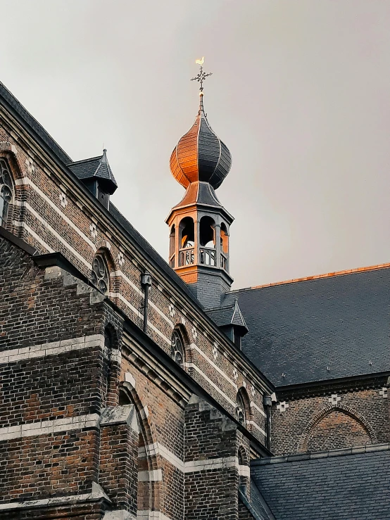 a clock that is on the side of a building, a photo, inspired by Geertgen tot Sint Jans, pexels contest winner, with great domes and arches, moody evening light, profile picture 1024px, color photo