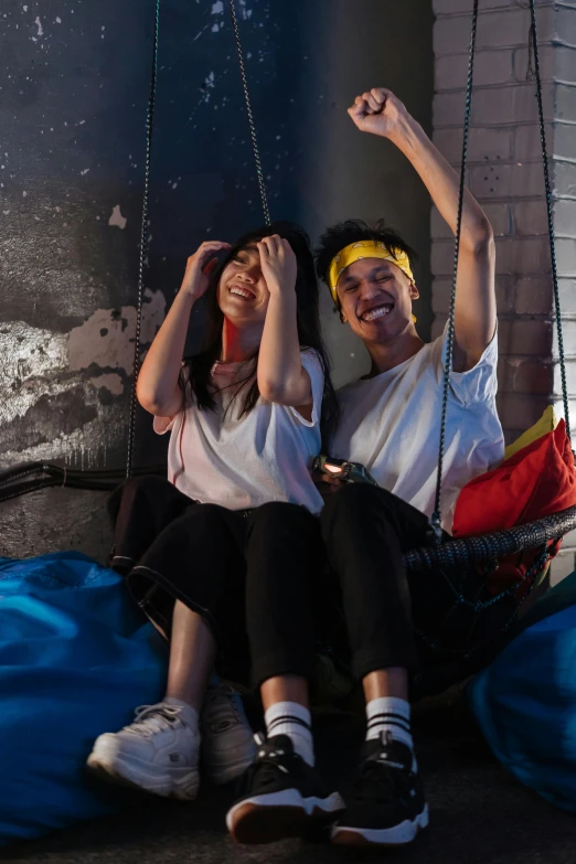 a man and a woman are sitting in a hammock, by Julia Pishtar, happening, rooftop party, kda and sam yang, softplay, excited