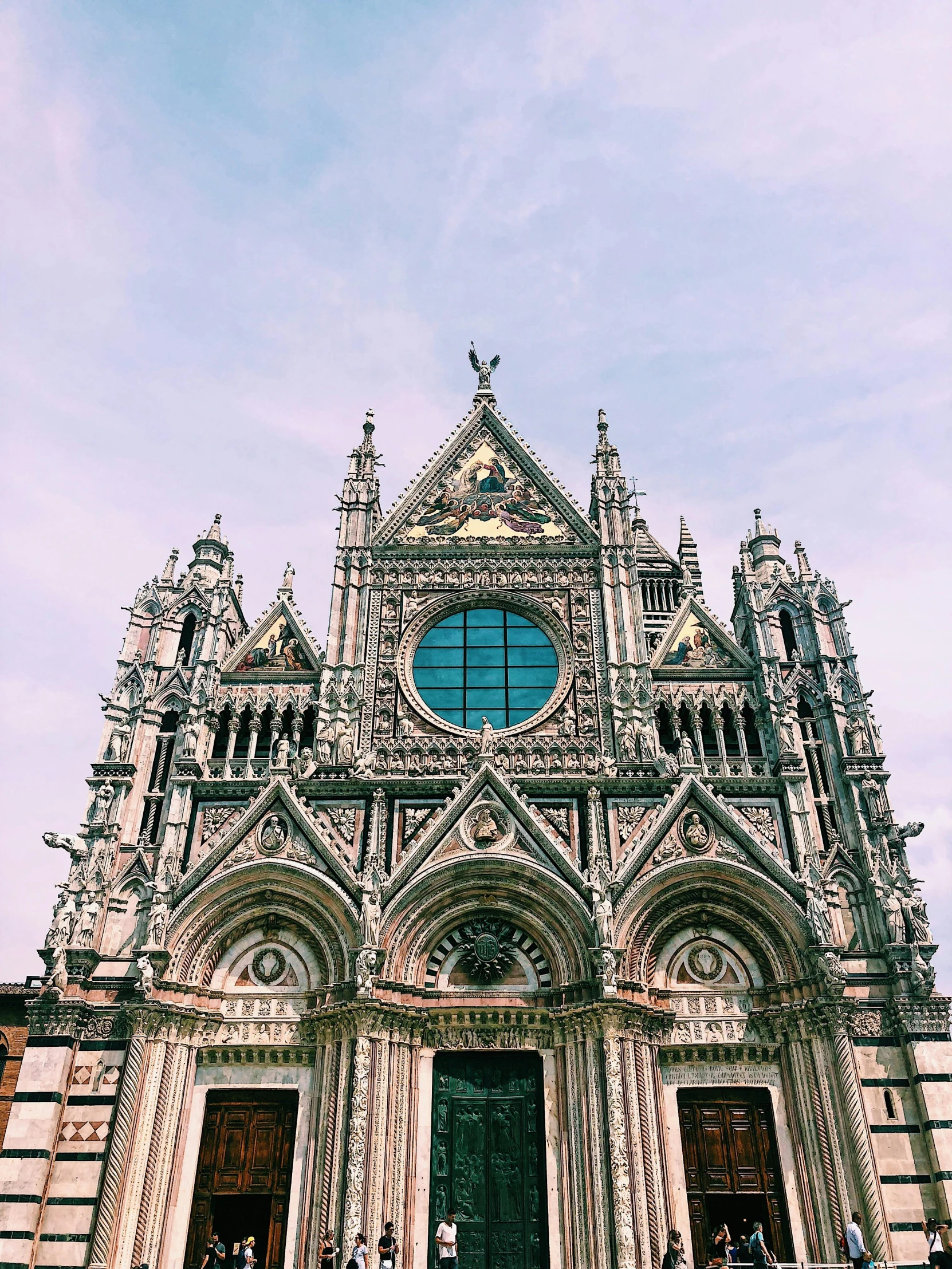 a group of people standing in front of a cathedral, an album cover, inspired by Francesco del Cossa, pexels contest winner, renaissance, 💋 💄 👠 👗, sienna, view up, instagram picture