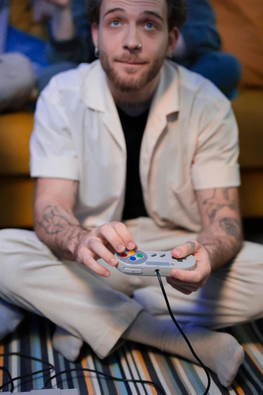 a man sitting on the floor playing a video game, trending on pexels, hyperrealism, super nintendo, smug smirk, muted colors. ue 5, holding it out to the camera