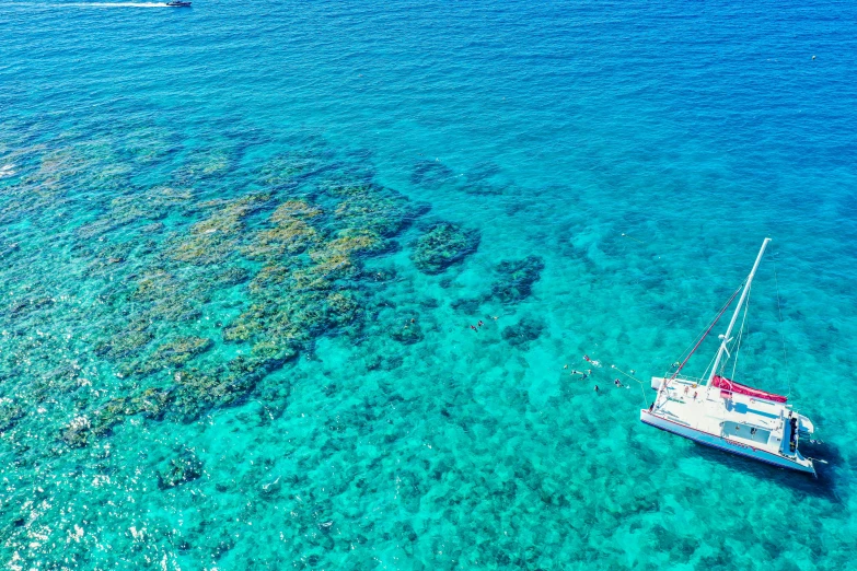 a couple of boats that are in the water, by Nicolette Macnamara, pexels, coral sea bottom, panoramic shot, maui, thumbnail