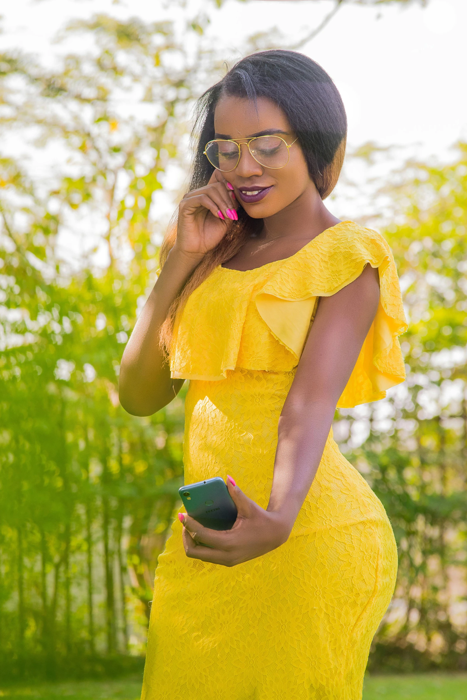 a woman in a yellow dress talking on a cell phone, by Chinwe Chukwuogo-Roy, pexels, wearing gorgeous clothing, 🐿🍸🍋