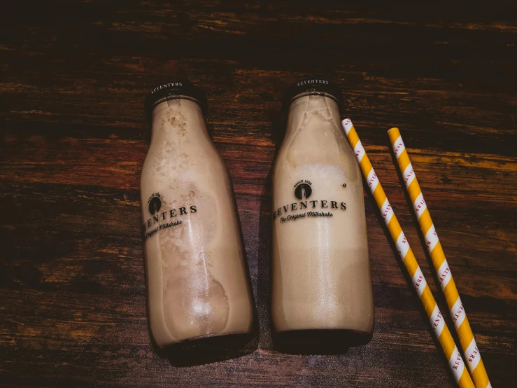 two bottles of milk and two straws on a table, pexels contest winner, reveries, iced latte, nexters, engraved
