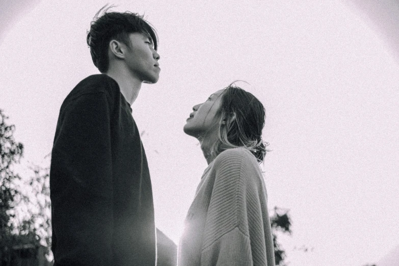 a man and a woman standing next to each other, by Jang Seung-eop, pexels contest winner, falling in love, cheekbones, looking upwards, grainy low quality