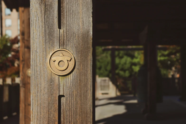 a wooden door with a smiley face on it, inspired by Itō Jakuchū, unsplash, golden hour sun, circular, quest marker, modeled