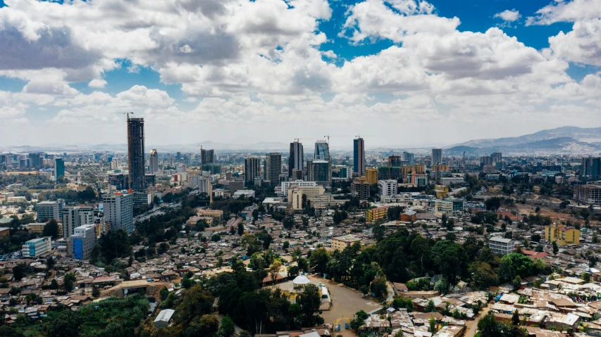 a view of a city from the top of a hill, an album cover, pexels contest winner, quito school, ethiopian, highrise business district, partly cloudy day, moroccan city