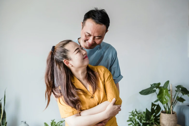 a man and a woman standing next to each other, pexels contest winner, mingei, head bent back in laughter, avatar image, asian female, maintenance