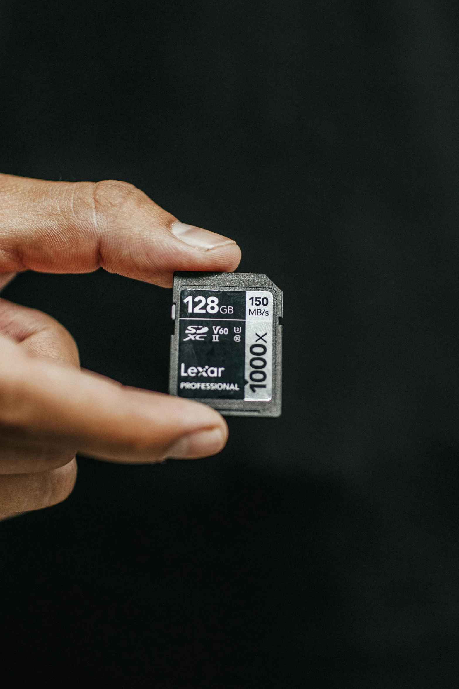 a person holding a micro sd memory card in their hand, by Jason Felix, unsplash contest winner, on a gray background, lofi, 12k ursa, 108 megapixels