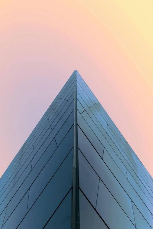 a very tall building with a sky in the background, an album cover, unsplash contest winner, modernism, triangular face, sharp edges. ultra detailed, lit in a dawn light, taken in the late 2010s