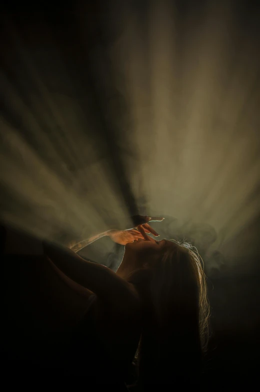 a woman holding an umbrella in the dark, an album cover, by Eglon van der Neer, pexels contest winner, light and space, cigarette smoke, upside down, holy rays, diffused backlight