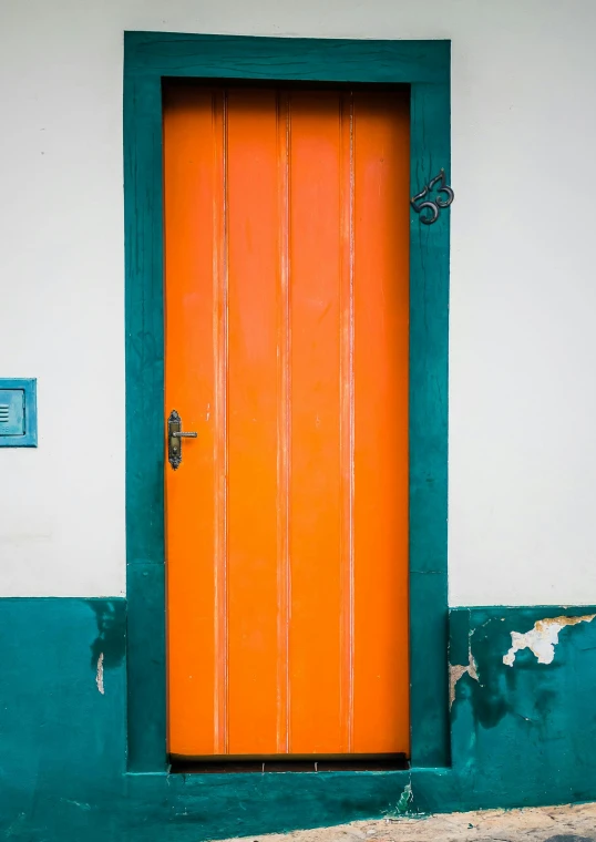 an orange door sitting on the side of a building, an album cover, pexels contest winner, brazil, happy colors, teal orange, historical photo