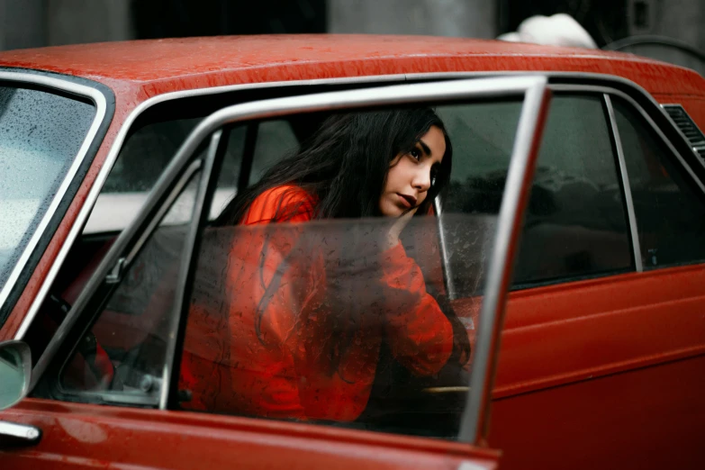 a woman sitting in the passenger seat of a red car, an album cover, inspired by Elsa Bleda, square, julia sarda, high quality image, oona chaplin
