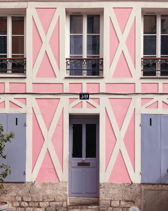 a pink and white building with blue shutters, a colorized photo, pexels contest winner, paris school, lgbtq, cottages, doorway, gif