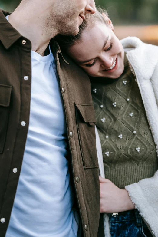 a man and a woman standing next to each other, trending on unsplash, wearing a cardigan, detail shot, happy couple, center of image