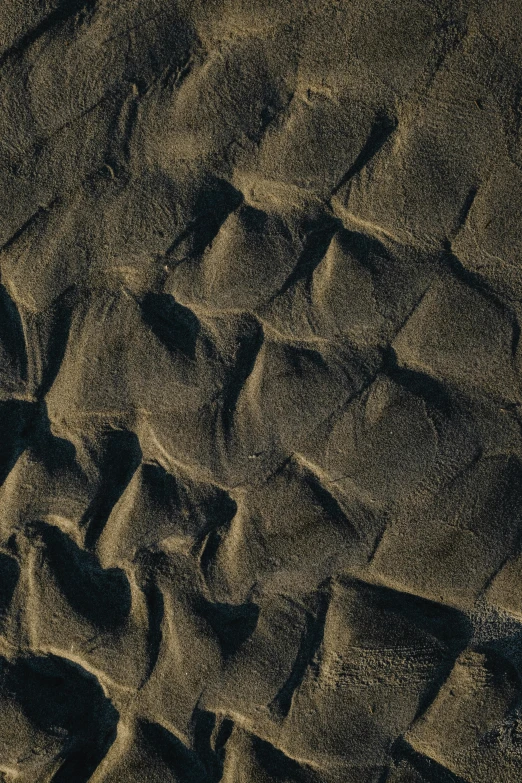 a red fire hydrant sitting on top of a sandy beach, a microscopic photo, trending on unsplash, land art, 4 k seamless mud texture, black sand, “ aerial view of a mountain, intricate wrinkles