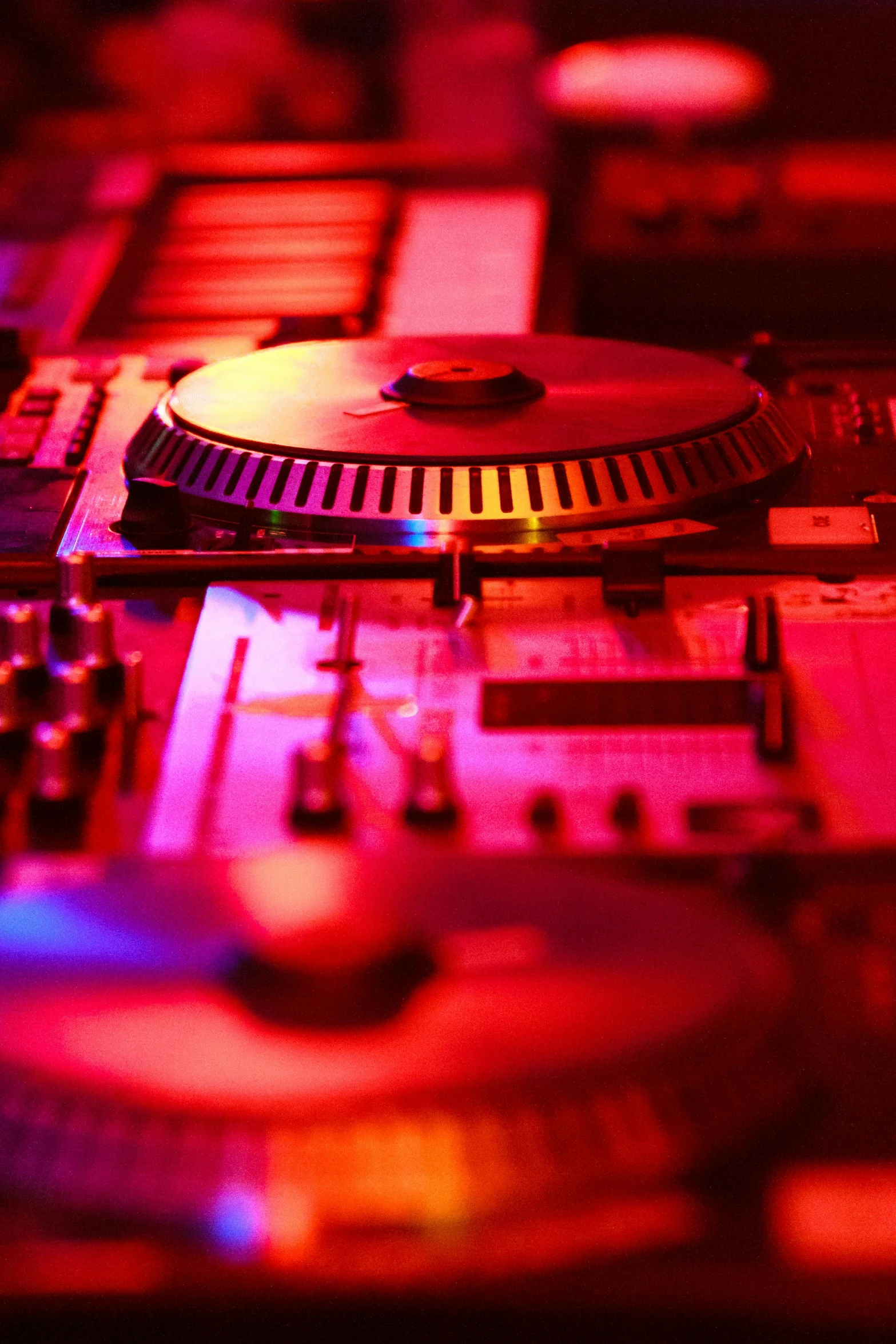 a dj controller sitting on top of a table, orange and red lighting, image of random arts, electronic components, commercially ready