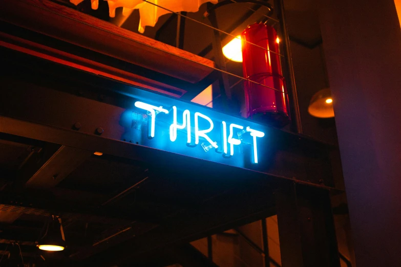 there is a neon sign that says thrift, by Drew Tucker, trending on unsplash, small hipster coffee shop, trash ; basement, profile image, blue light