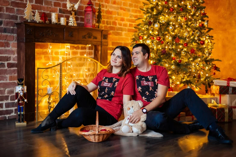 a man and woman sitting in front of a christmas tree, ukraine. professional photo, red t-shirt, 15081959 21121991 01012000 4k, brown