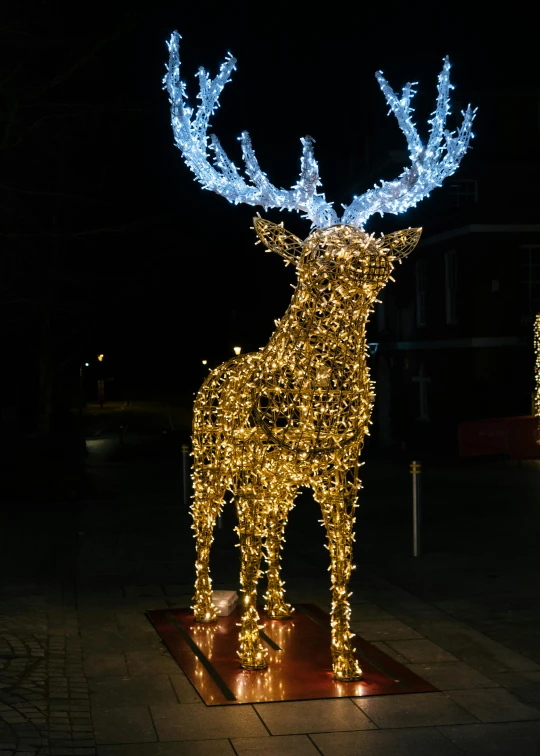 a statue of a deer is lit up at night, inspired by Rudolph F. Ingerle, pexels contest winner, shiny silver with gold trim, square, ultra detailed wire decoration, high quality image