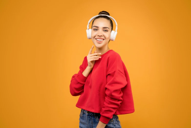 a young woman wearing headphones and smiling at the camera, trending on pexels, antipodeans, orange and white, avatar image, various posed, full dynamic colour