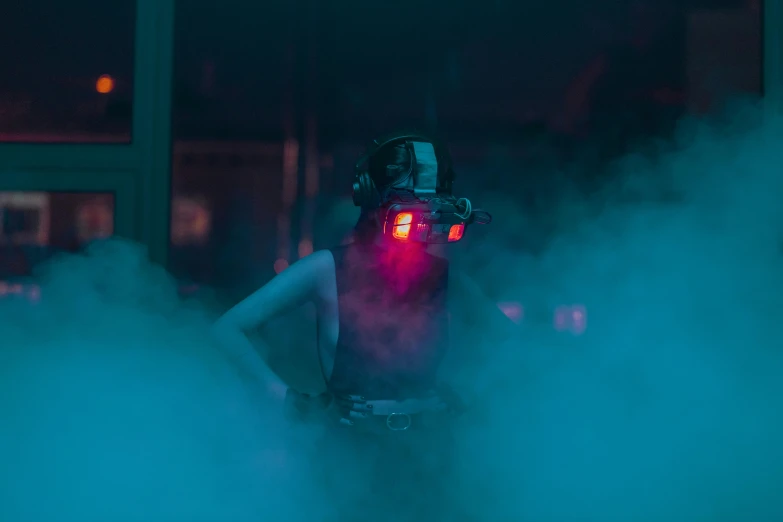 a man that is standing in the fog, cyberpunk art, inspired by Elsa Bleda, unsplash contest winner, conceptual art, she wear red eyed gasmask, headphones dj rave, very smoky cyberpunk paris bar, blue lens airsoft mask
