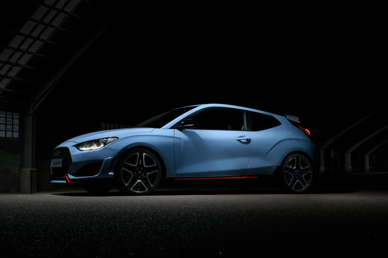 a blue car parked in a garage at night, it has a red and black paint, press shot, square, high quality photo