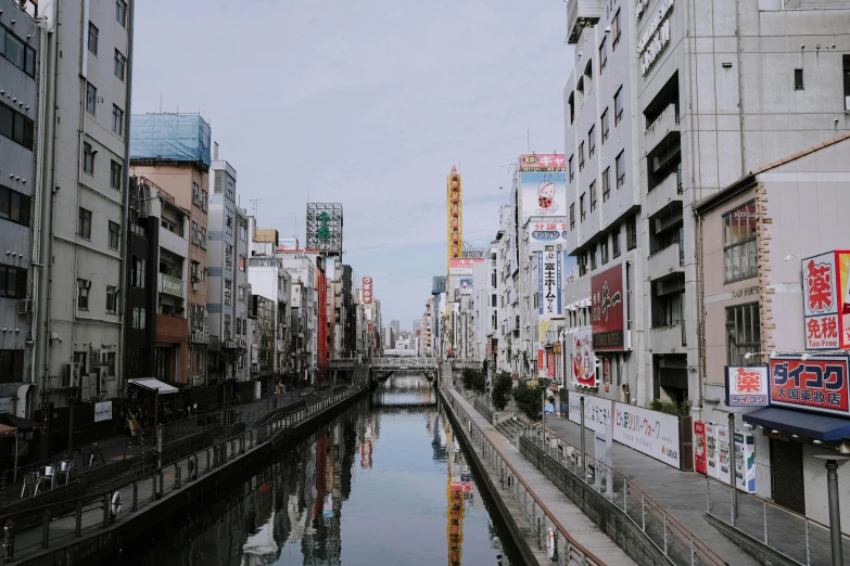 a river running through a city next to tall buildings, inspired by Kōshirō Onchi, unsplash contest winner, streetscape, kumamoto, canal, 2000s photo