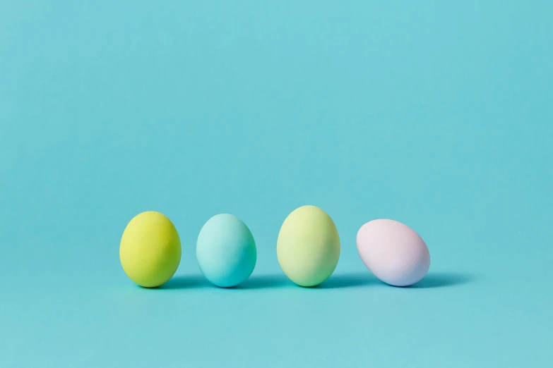 a row of colored eggs on a blue background, by Alison Geissler, trending on unsplash, color field, gradient pastel green, instagram post, cyan and magenta, subtle detailing