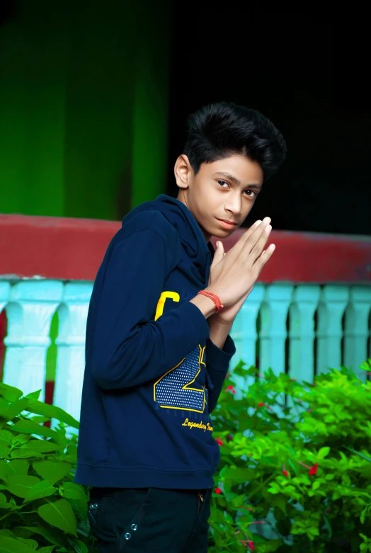 a man that is standing in the grass, a picture, by Rajesh Soni, pexels contest winner, sumatraism, portrait of 14 years old boy, with index finger, pose model, praying