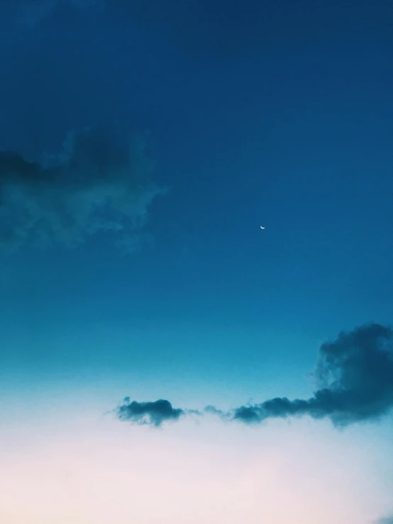 a couple of people standing on top of a beach next to the ocean, inspired by Elsa Bleda, unsplash, minimalism, night clouds, ✨🕌🌙, cerulean blue, spaceship in the sky