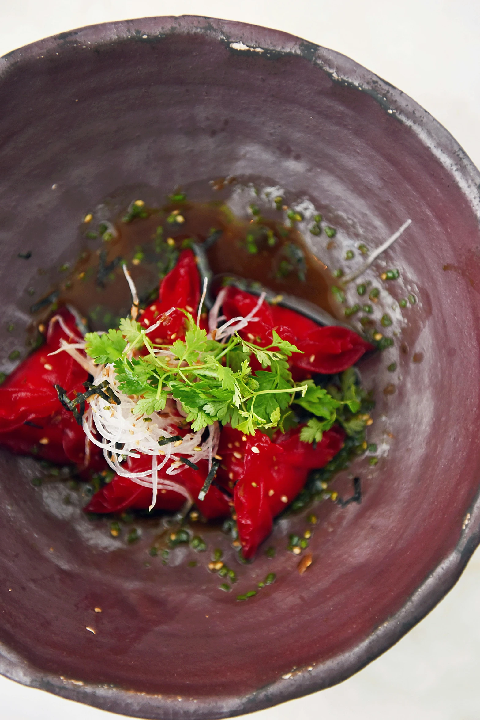 a close up of a bowl of food on a table, stingray, crimson, infused, dreamy